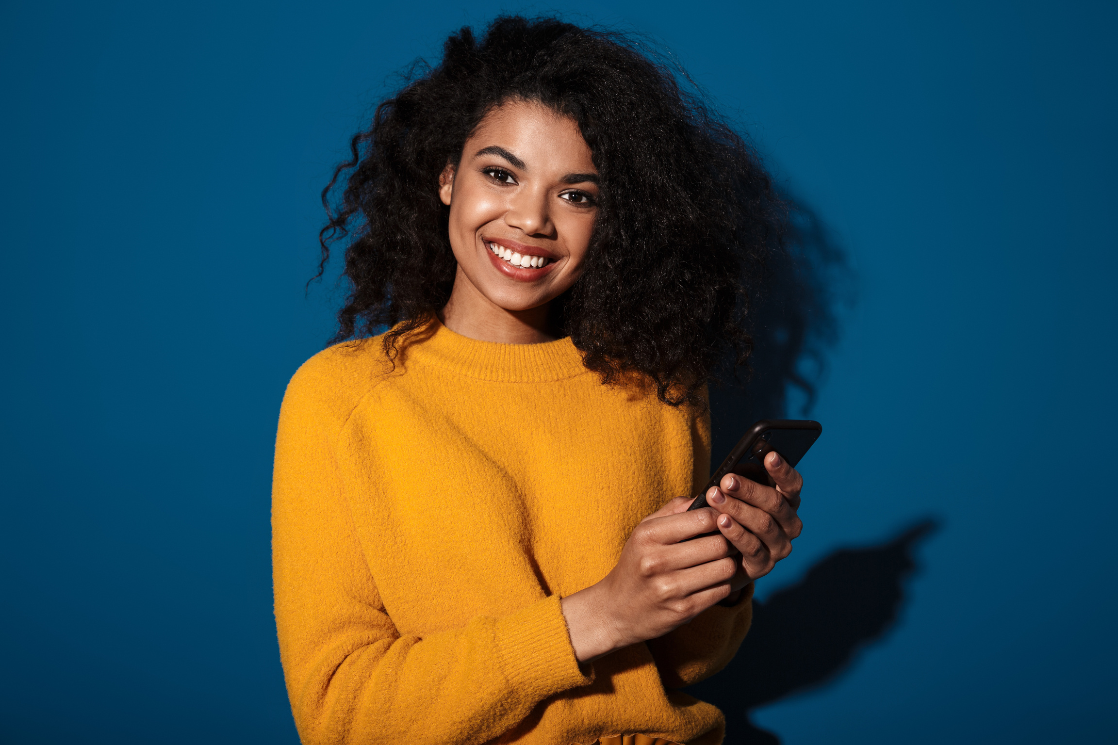 Smiling Happy African Woman Using Mobile Phone.